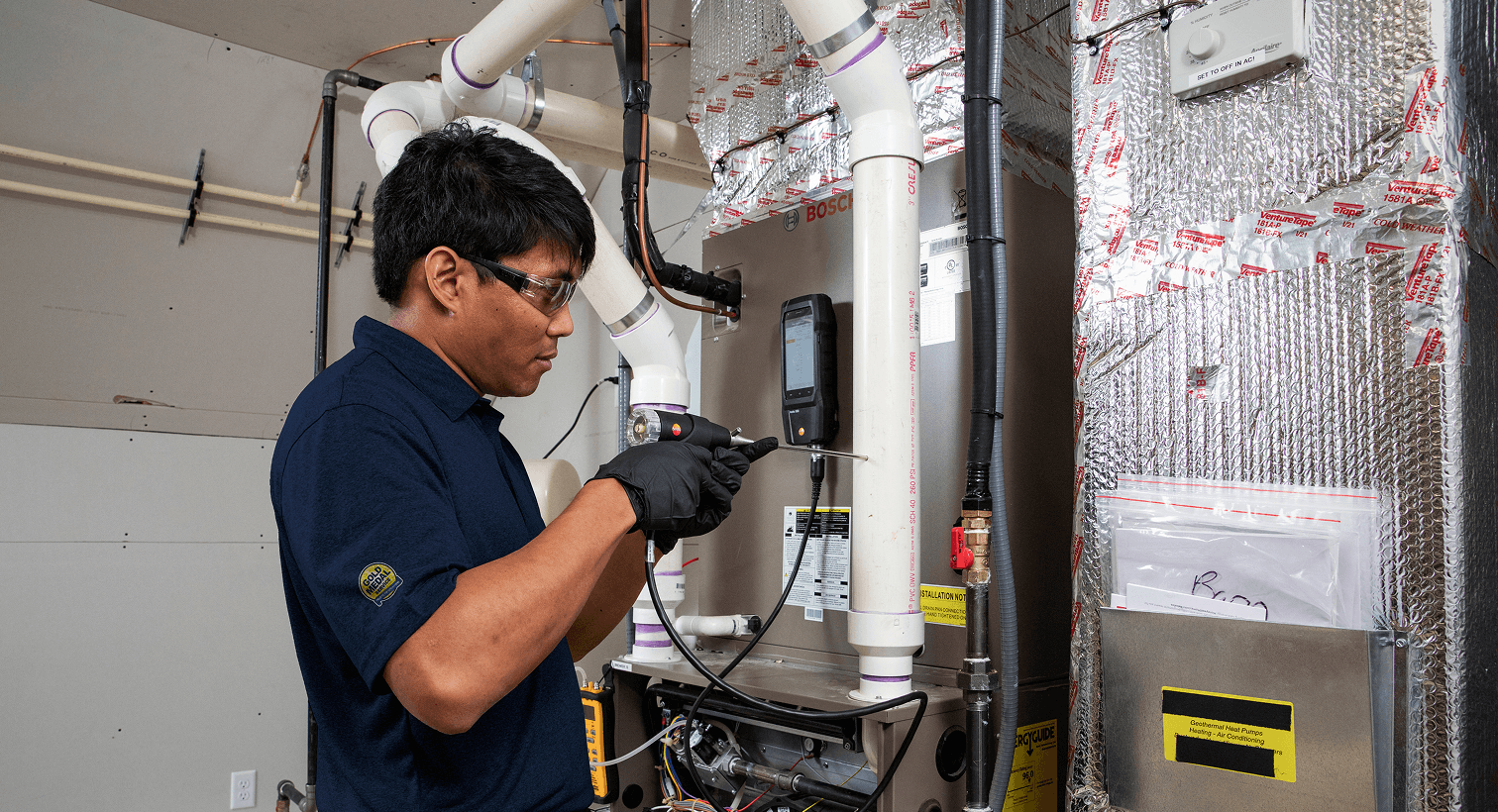 A man working on a heating unit