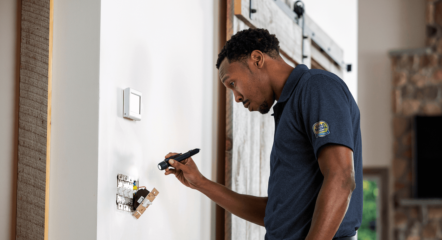 Technician looking at an electric outlet
