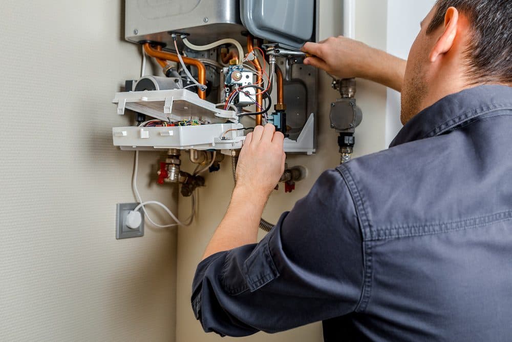 A Gold Medal technician repairing a boiler