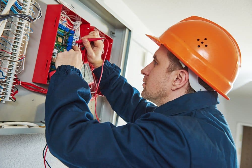 A Gold Medal technician repairing an electric issue inside of a home