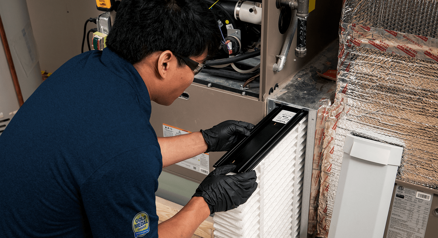 Technician performing AC maintenance