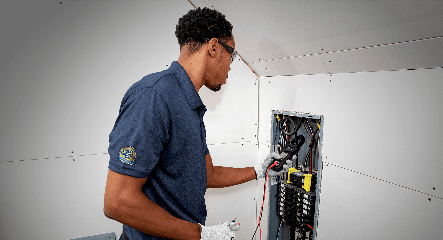 A man checks an electrical panel