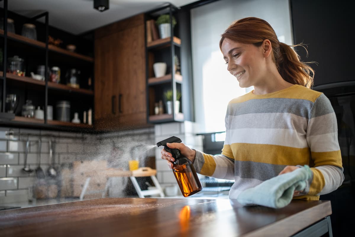 Woman cleaning with spray bottle