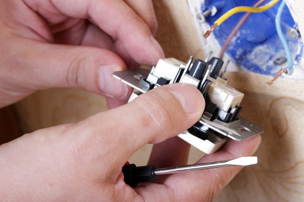 A technician working with electrical items