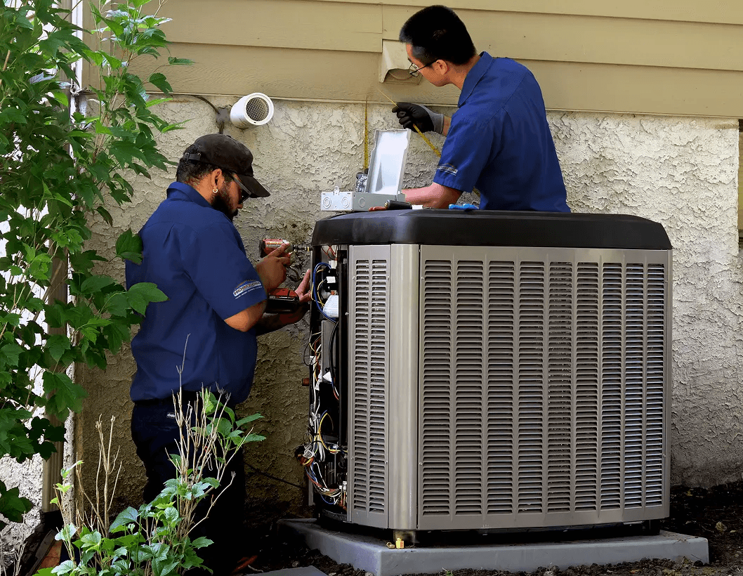 Two technicians performing an AC replacement